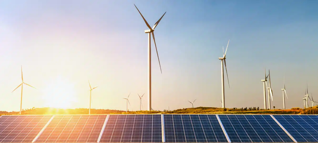 large solar panels and wind turbines showing clean energy